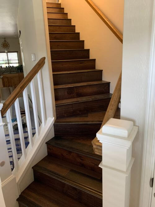 Picture of Armstrong Woodland Relics Storied Farmstead, an engineered hardwood flooring, installed in stairs. It combines oak, hickory and birch into a reclaimed, weathered, random wood board flooring look, on closeout sale at Colonial Decorators in Grants Pass, Oregon.