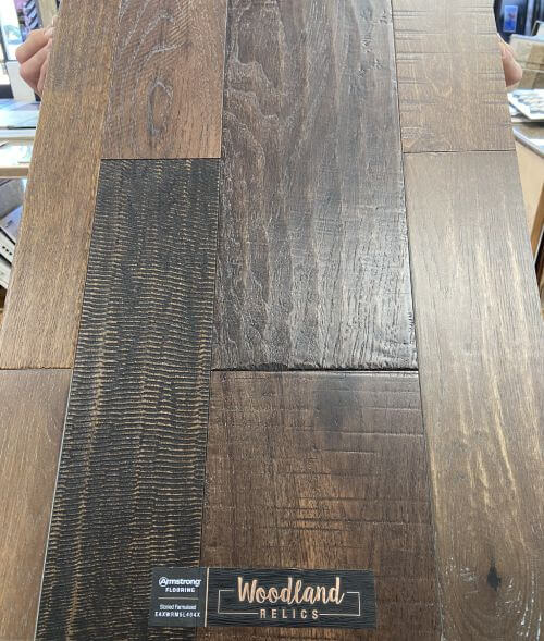 Sample board of Armstrong Woodland Relics Storied Farmstead engineered hardwood flooring that combines oak, hickory and birch into a reclaimed, weathered, random wood board flooring look, on closeout sale at Colonial Decorators in Grants Pass, Oregon.